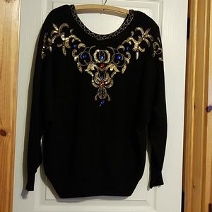 Sweater with gold,  red, and blue embellishments